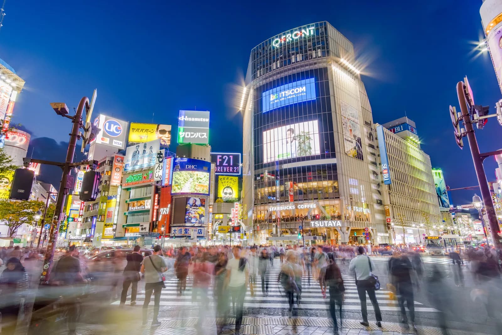 The screens around Shibuya Scramble Crossing lit at dusk, Tokyo